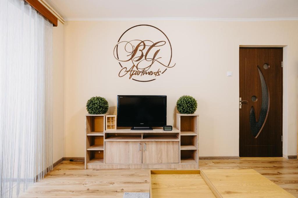 a living room with a flat screen tv on a wall at B-G Apartments in Gheorgheni