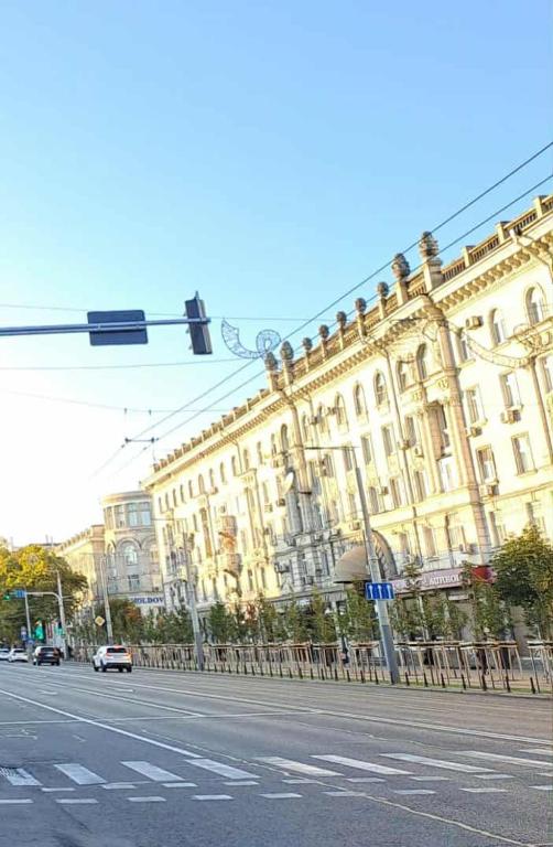 a large building on a city street with a traffic light at Apartament spațios în centrul Chișinăului! in Chişinău