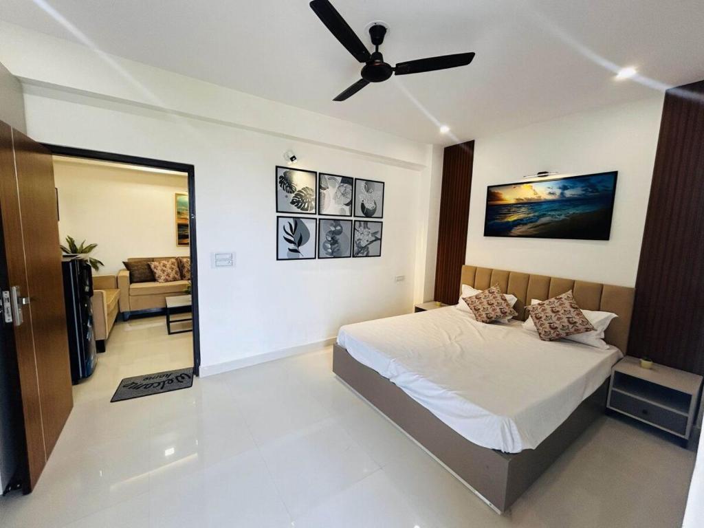 a bedroom with a bed and a ceiling fan at Cozyआश्रय 1BHK with peaceful balcony in Siroli