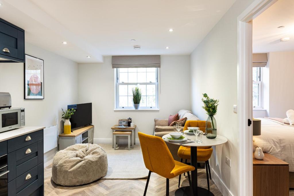 a small living room with a bed and a table at Rock Mill 1 Bed Apartment 21 in Stoney Middleton
