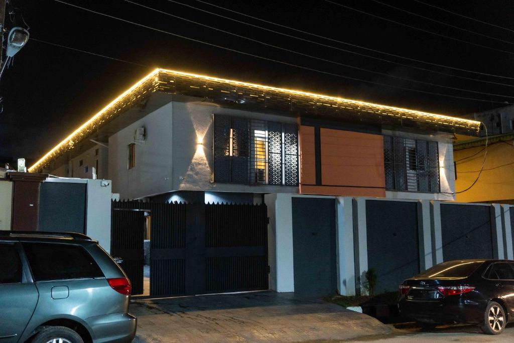 a house with lights on top of it at night at lusso Court in Agidingbi