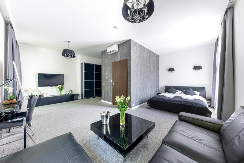 a living room with a bed and a table at Stara Stołówka in Brzeg Dolny