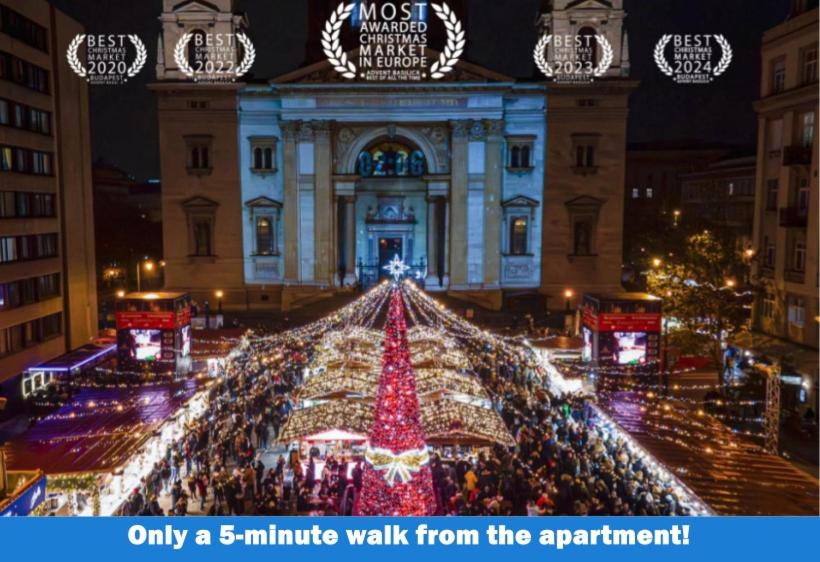 a large christmas tree in front of a building at Luxe Studio in City Center with FREE Parking in Budapest