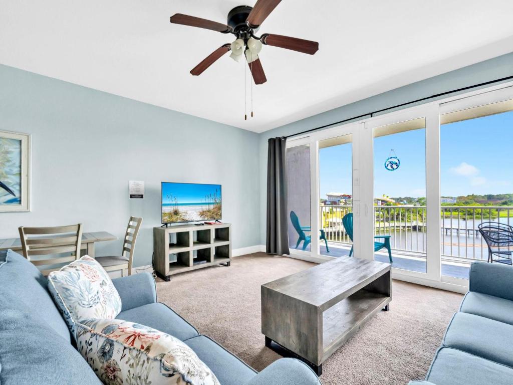 a living room with a couch and a ceiling fan at Laketown Wharf 331 in Panama City Beach