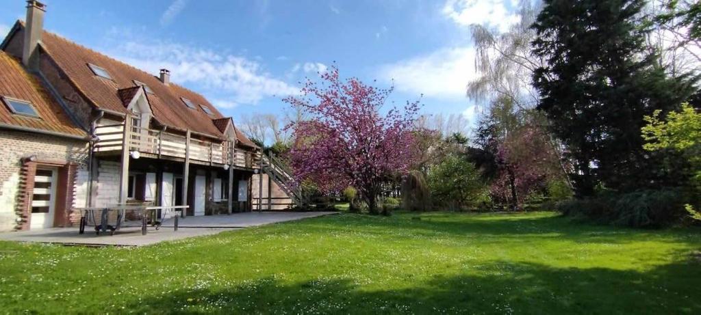 a house with a green lawn in front of it at Domaine des Célestins - Captive des Sables in Bernay-en-Ponthieu