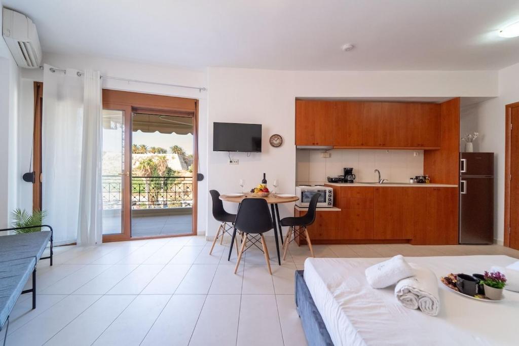 a bedroom with a bed and a kitchen with a table at Venetian Studio in the Centre 1 in Heraklio