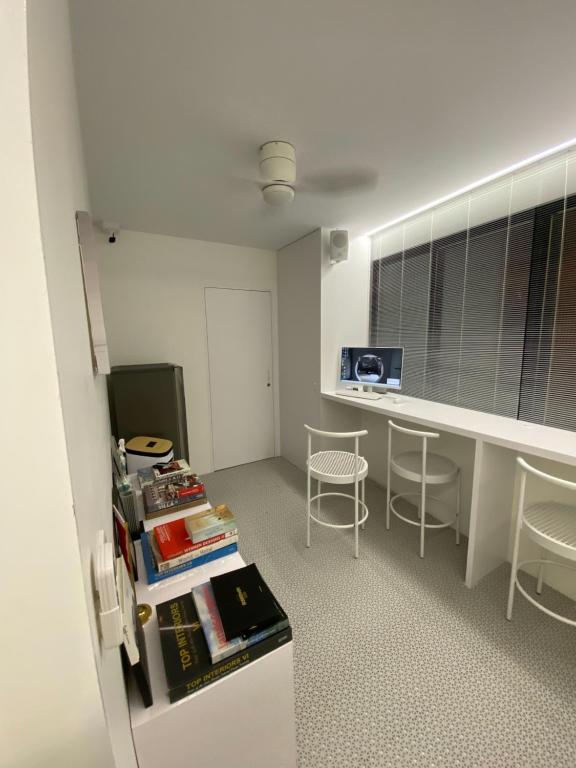 an office with a desk and chairs in a room at 16 Post Station Single Tour in Hengchun