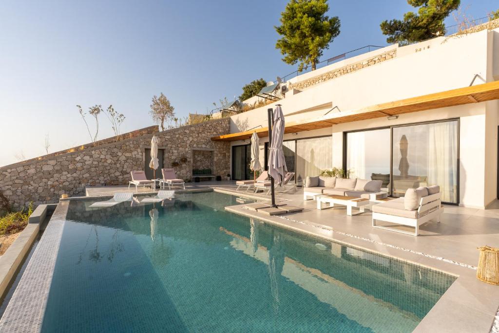 a swimming pool in the backyard of a house at Villa Lulu Lefkada in Kalamitsi
