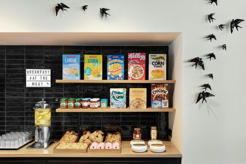 A self-service breakfast counter with cereal, pastries, fruit, yogurt and drinks.