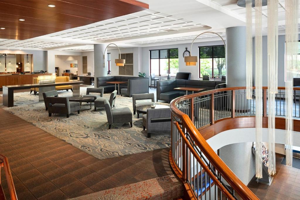 a lobby with a waiting area with tables and chairs at DoubleTree by Hilton Hotel Boston - Downtown in Boston