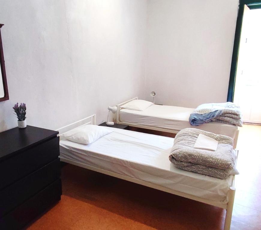 En eller flere senge i et værelse på Alojamento Raymundo