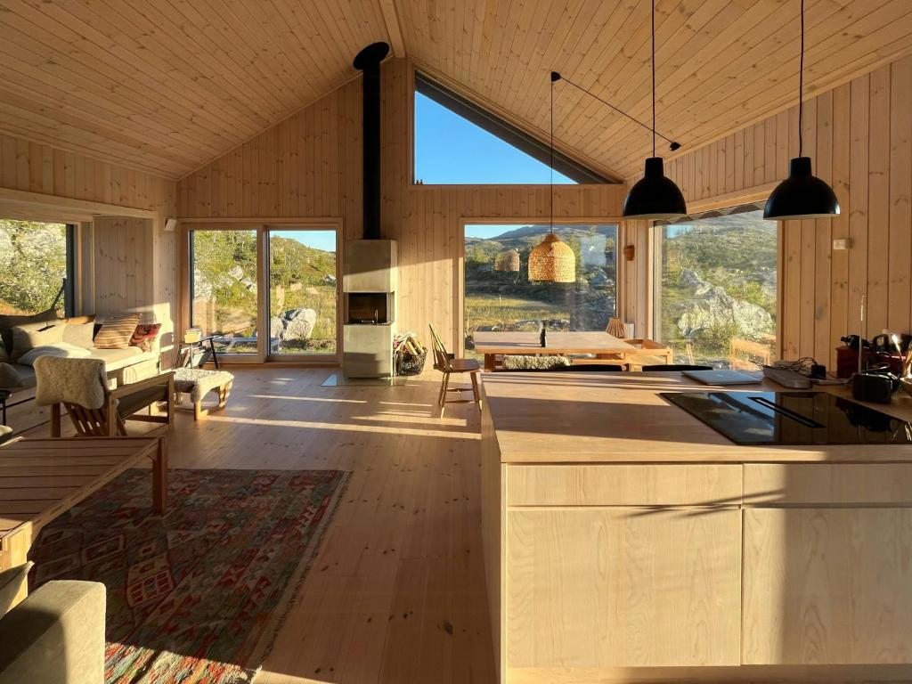 a large room with a living room with a table at Architect-Designed Cabin With Views Of Sigdal in Skadeland