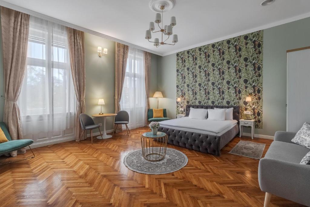 a living room with a bed and a couch at Central Park Rooms in Oradea