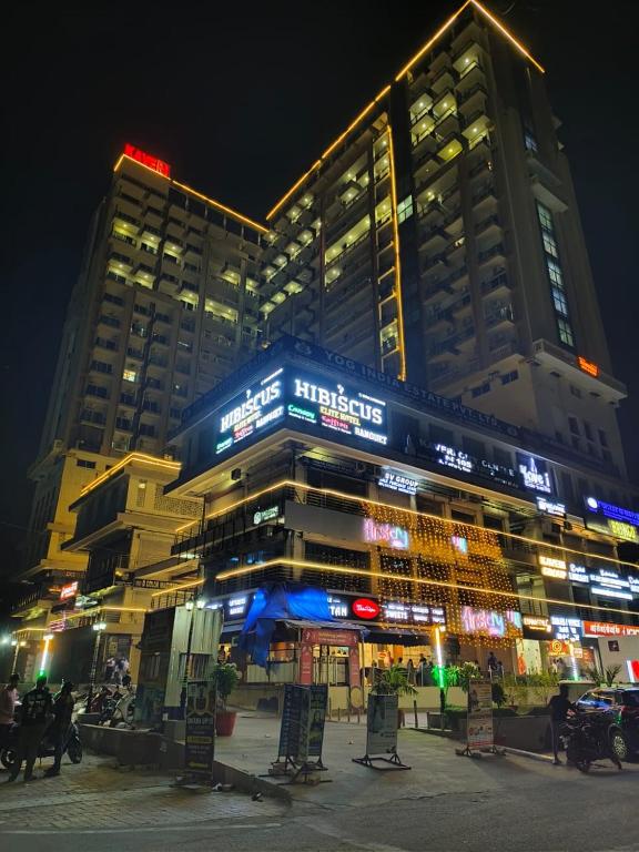 a building at night with chairs in front of it at Anantya Inn in Greater Noida