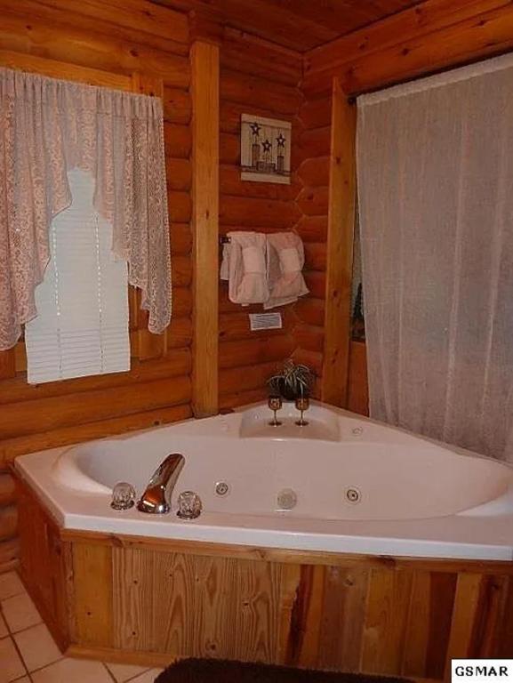 a bathroom with a tub in a cabin at Unforgettable Dreams By Avada Properties in Sevierville
