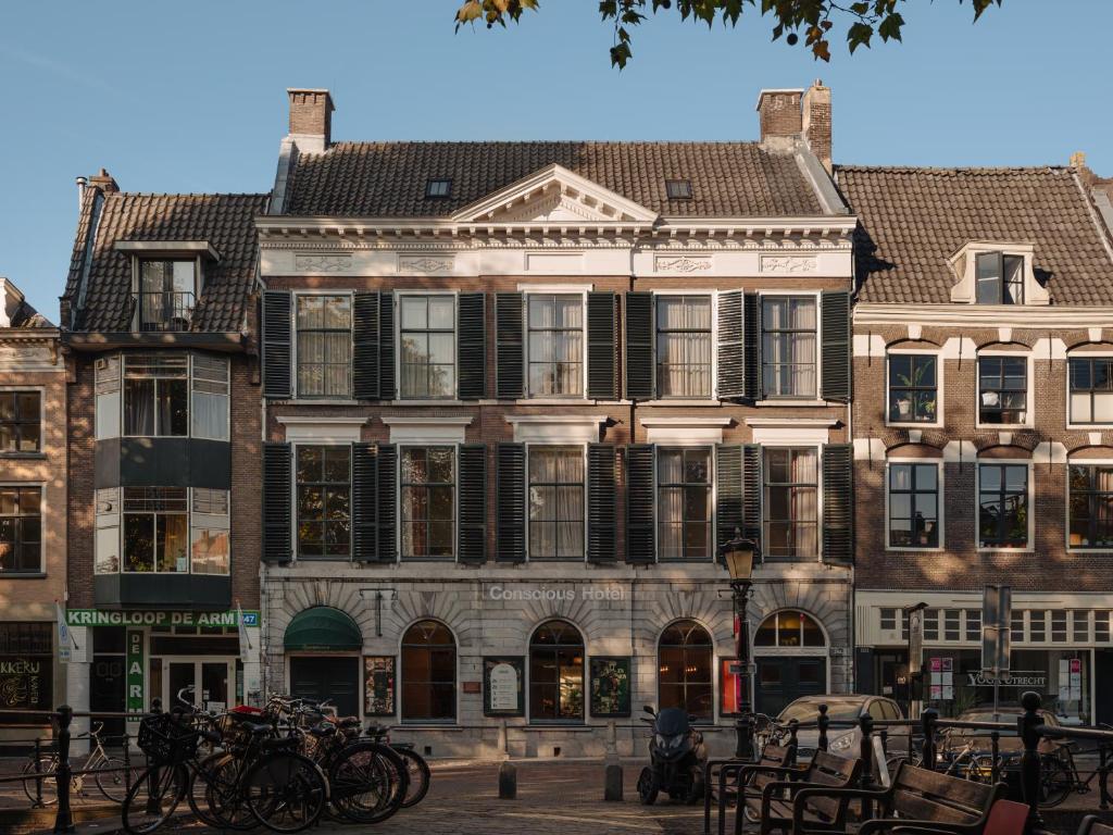 a large building with bikes parked in front of it at Conscious Hotel Oudegracht in Utrecht