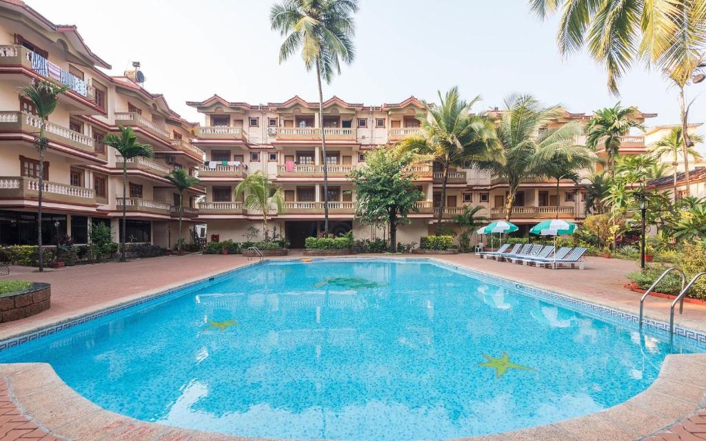 a large swimming pool in front of a building at GGH - Ocean Nest, Goa in Candolim