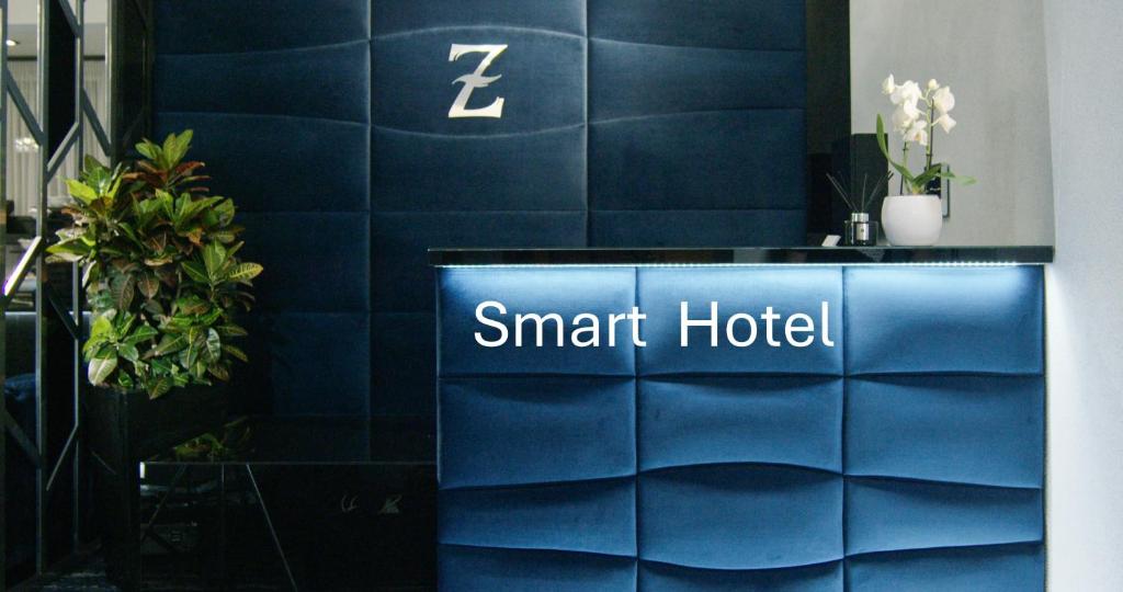 a blue wall with a sign that reads smart hotel at Z Rooms Boutique in Zalaegerszeg