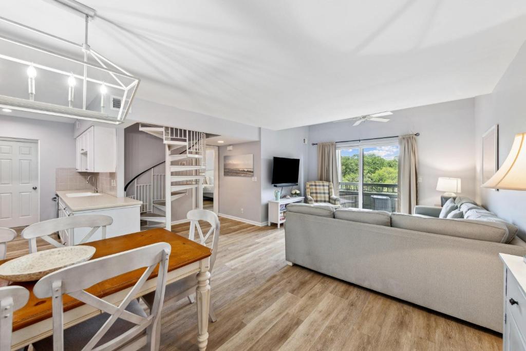 a living room and kitchen with a couch and a table at 891 Ketch Court in Hilton Head Island
