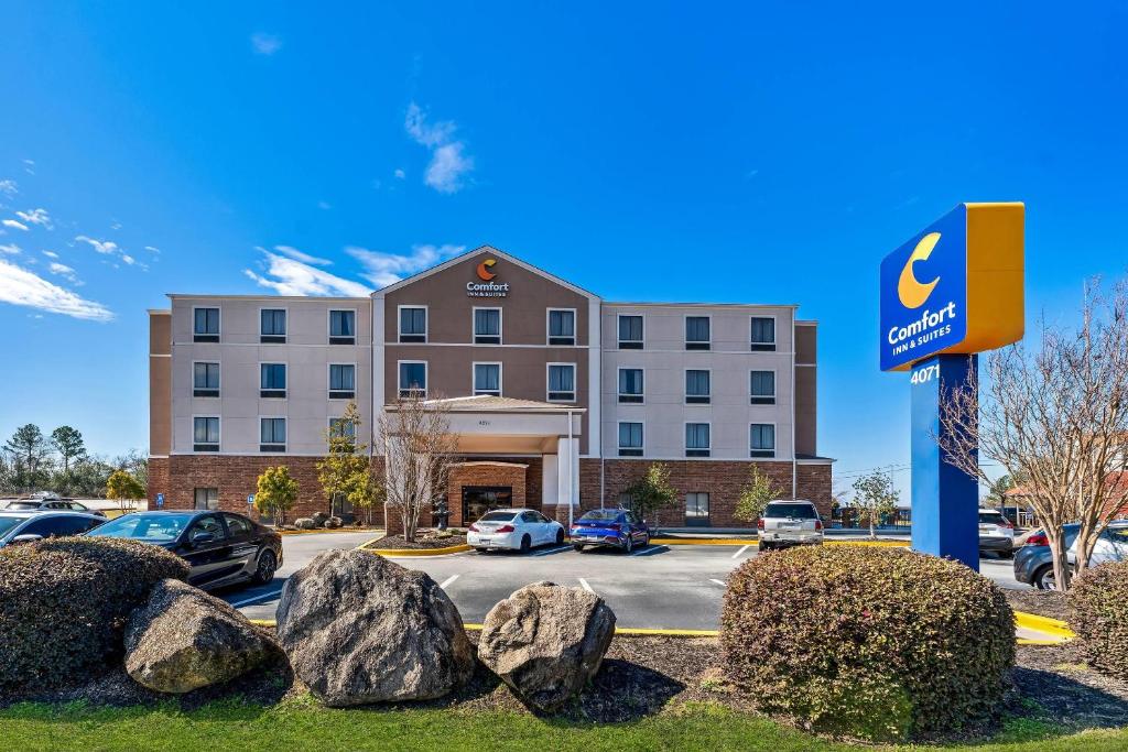 a hotel building with cars parked in a parking lot at Comfort Inn & Suites Augusta West Near Fort Gordon in Augusta