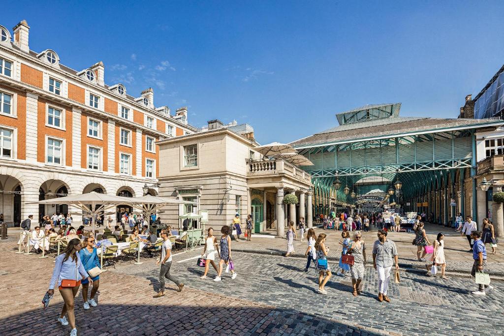 a group of people walking on a street in a city at Covent Garden Beautiful Designed Home Sleeps 6 in London
