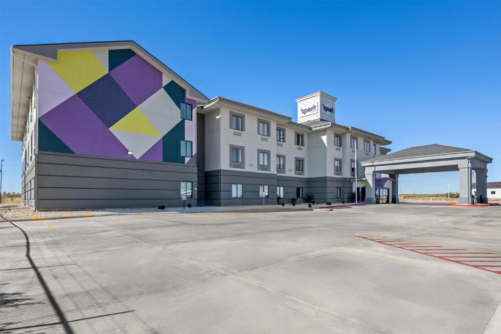a building with a mural on the side of it at Spark by Hilton Fort Stockton in Fort Stockton