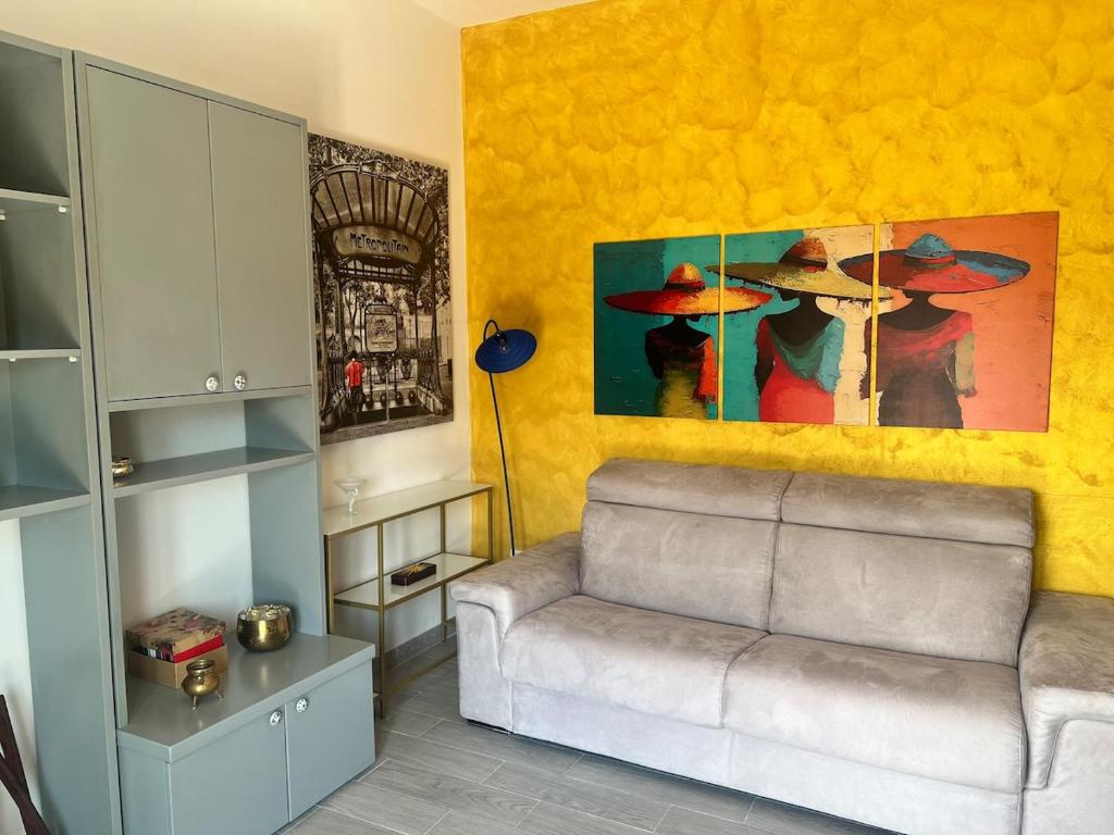 a living room with a couch and a painting at TheSun in Legnano