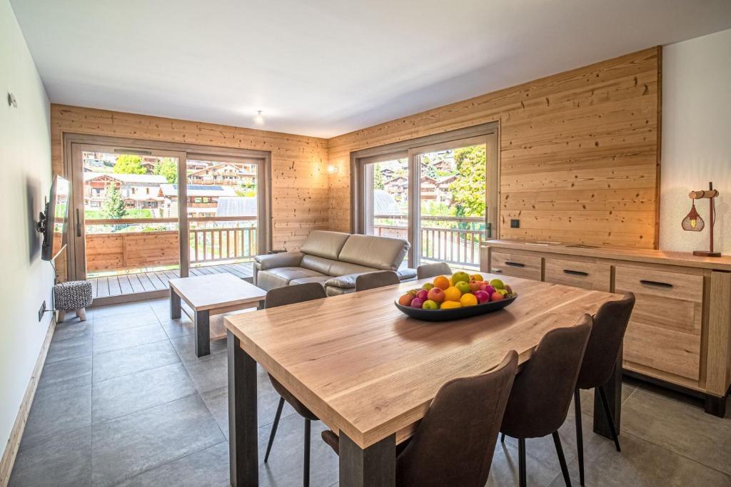 un salon avec une table avec un bol de fruits dessus dans l'établissement Coche, superbe appartement terrasse vue montagne, à Champagny-en-Vanoise