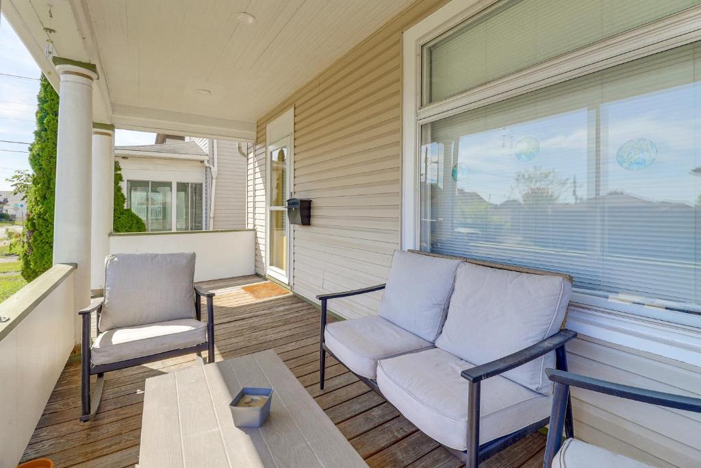 a porch with two chairs and a table and a window at 1 Mi to Dtwn and Franciscan University Home with Yard in Steubenville