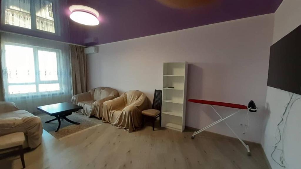 a living room with two chairs and a table at Apart in Ivano-Frankivsʼk