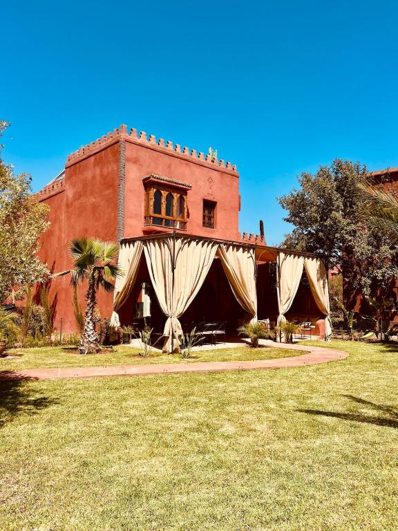 an old building with a curtain in front of it at Villa Dar Al Hayat in Marrakesh