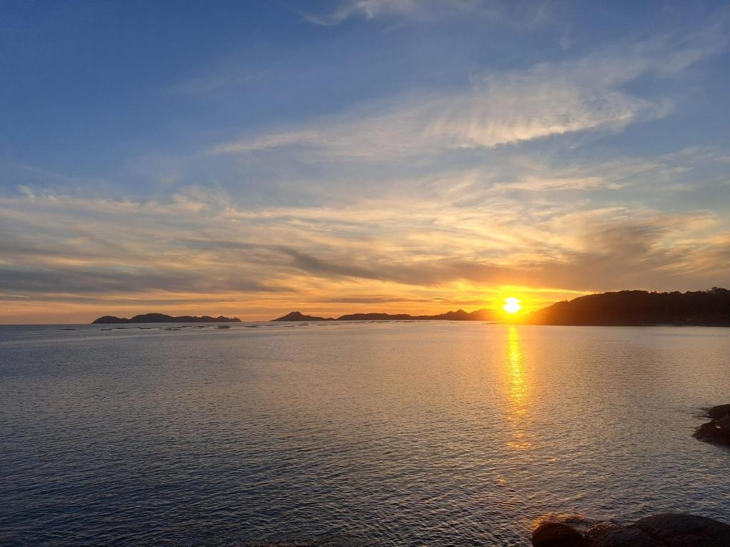 a sunset over a large body of water at Petit studio centre ville in Montreux