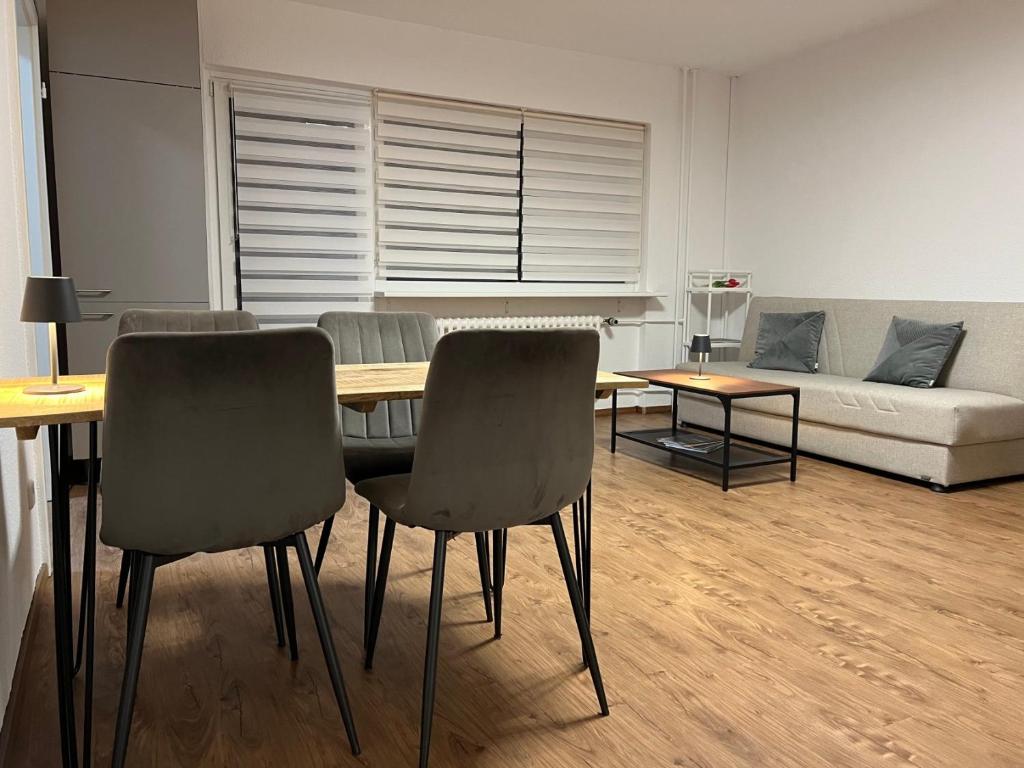 a living room with a table and chairs and a couch at LuxusCityApartment in Berlin