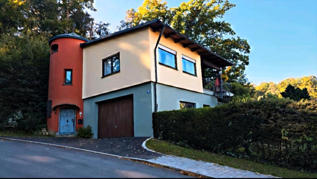 a house with a garage on the side of a road at Zum Waldschlössl im Vilstal in Aldersbach