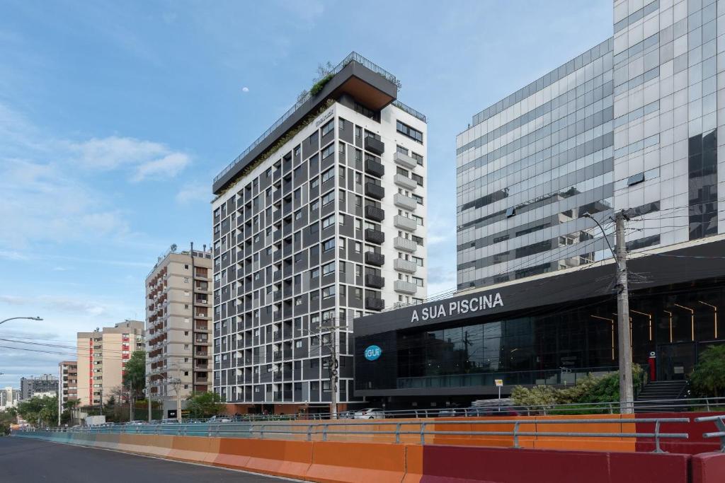 a tall building with a sign on the side of it at GO Carlos Gomes in Auxiliadora