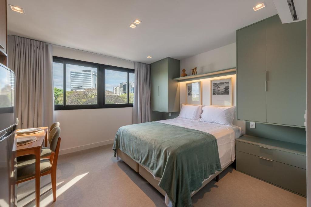 Ένα ή περισσότερα κρεβάτια σε δωμάτιο στο GO Carlos Gomes