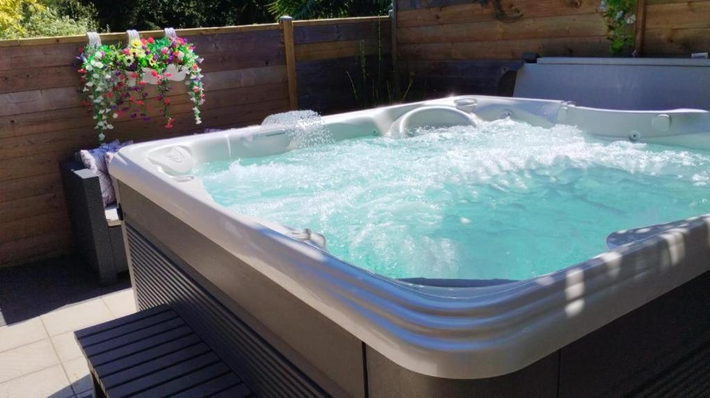 a large hot tub with water in a backyard at Nuit etoile avec Jacuzzi prive in Fouesnant