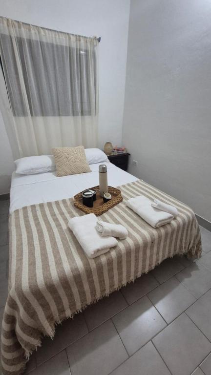 a bedroom with a bed with towels on it at Lumina in General Roca