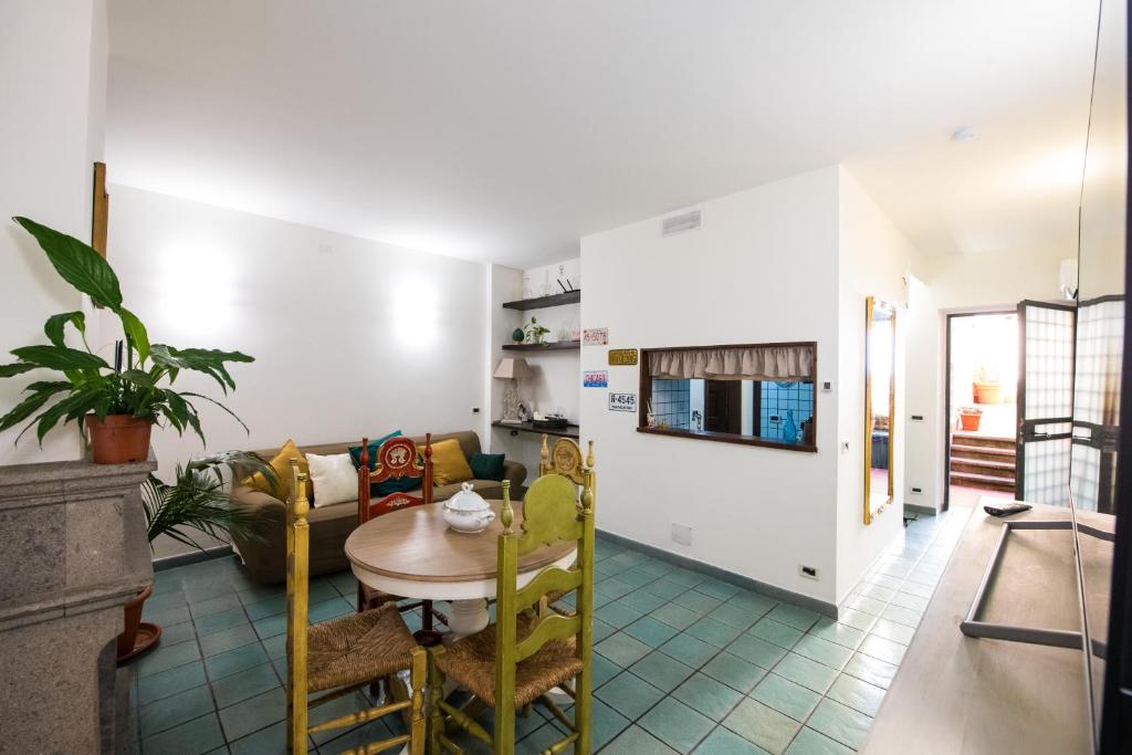 a dining room and living room with a table and chairs at Blue Goose Apartment in Ronciglione