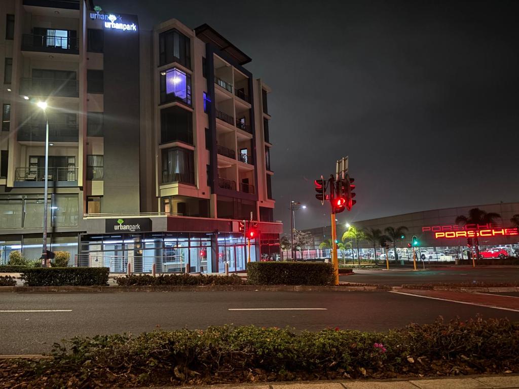 a city street at night with a building and a traffic light at Urban Park K001, Umhlanga Rocks in Durban