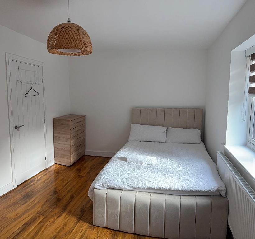 a small bedroom with a bed and a window at Large Double Room in Longbridge