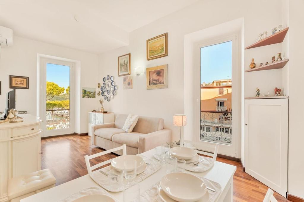 a living room with a table and a couch at La Loggia del Delfino 5 Terre Sea View AC in Lerici