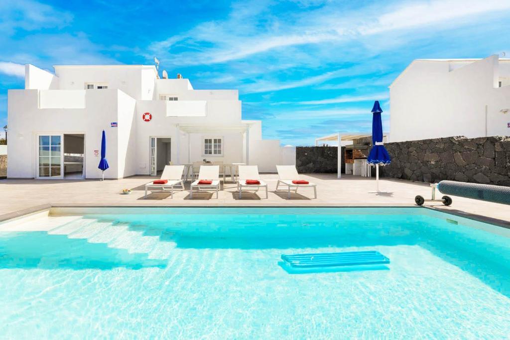 a swimming pool in front of a villa at Villa Yaiza Secret 3 in Yaiza