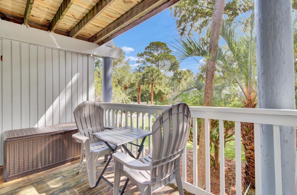a porch with two chairs and a table at Lagoon Villas 13 by Wild Dunes, with Amenities in Isle of Palms