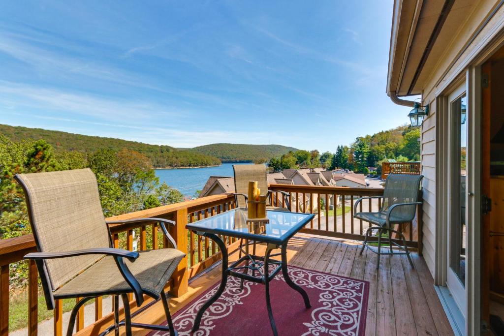 a balcony with chairs and a table and a view of the water at Deep Creek Lake Townhome with Deck and Water Views in Oakland