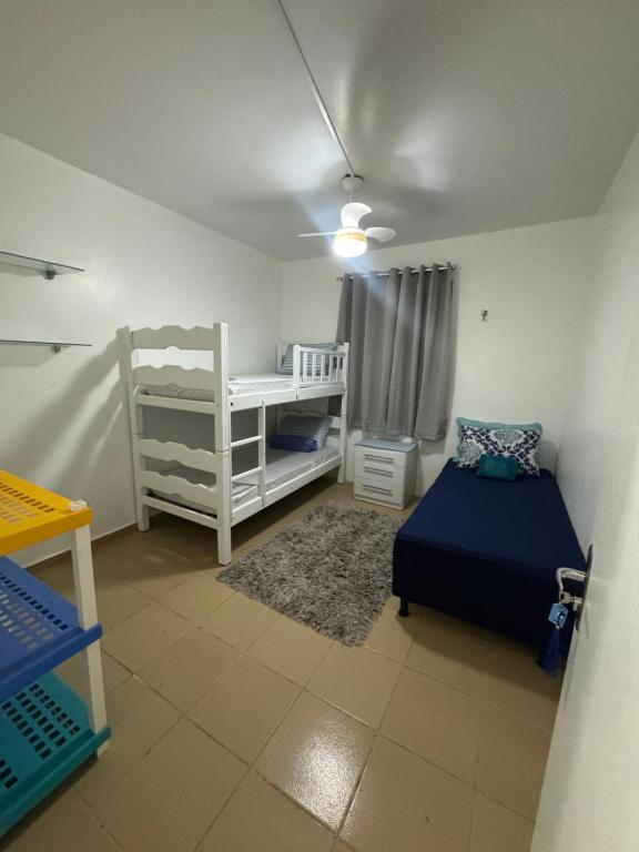 a room with two beds and a crib in it at Oásis a 1km Parque COP30 in Belém