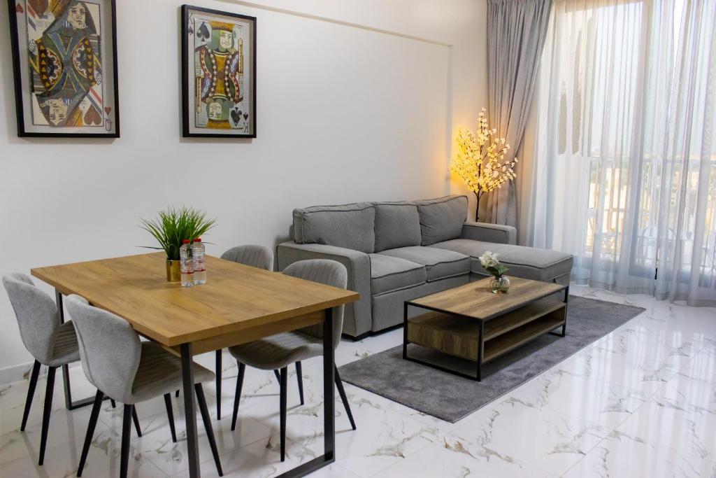 a living room with a couch and a table at Marina Retreat Stylish One Bedroom by Hala Homes in Ras al Khaimah