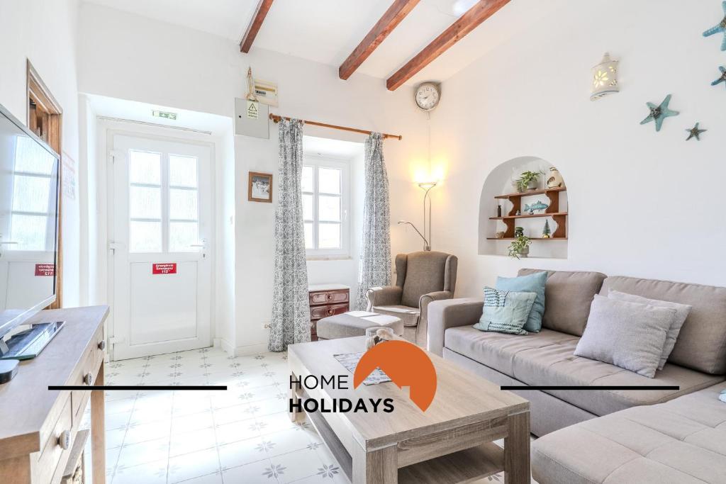 a living room with a couch and a table at #237 Vivenda Lilia by Home Holidays in Albufeira