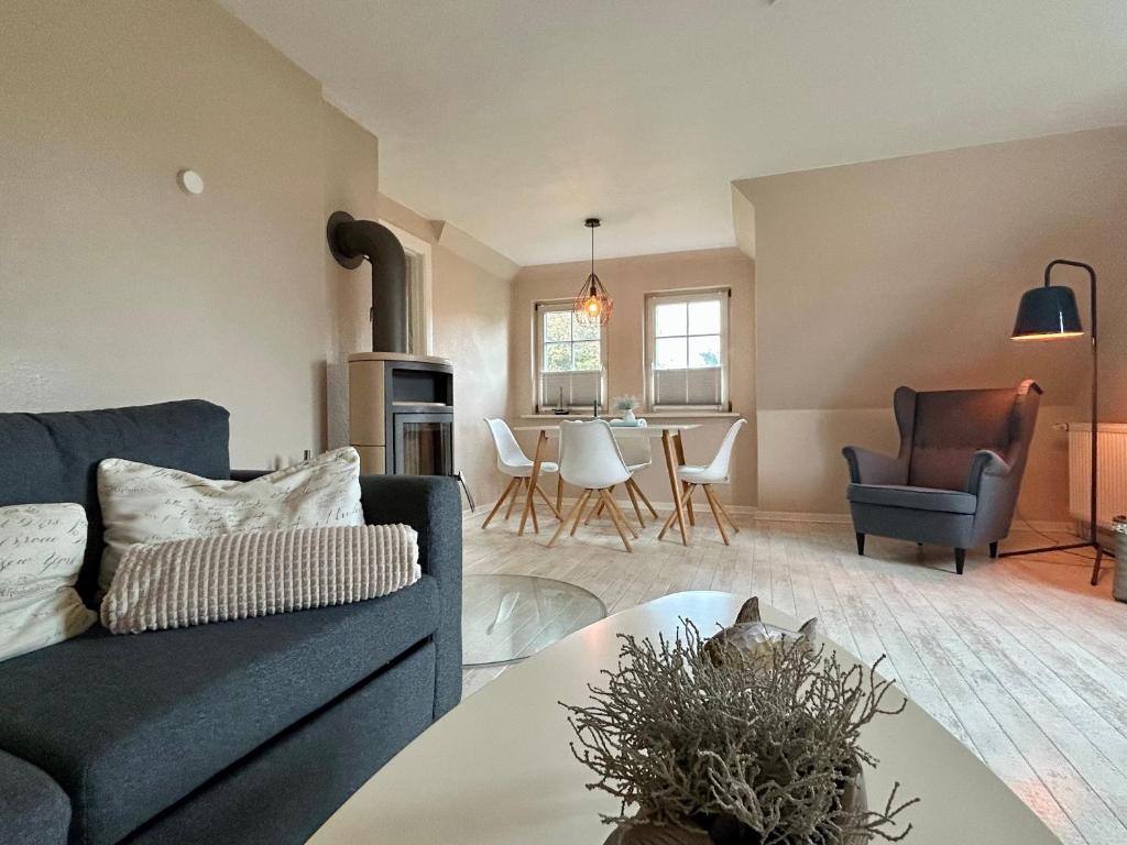 a living room with a couch and a table at Kleinod Appartement Stina in Sankt Peter-Ording