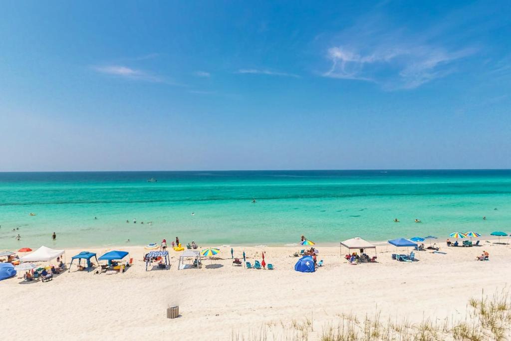 a group of people on a beach with the ocean at Pinnacle Port C2-404 in Panama City Beach